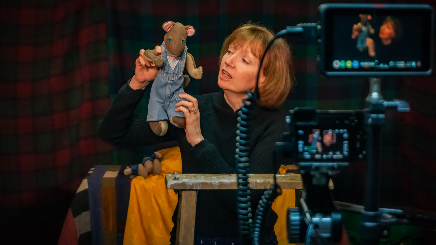 Kathy and a puppet, on set
